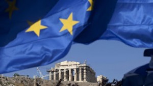 A Greek national flag flies beneath the Parthenon temple on Acropolis hill in Athens, Greece, on Tuesday, May 1, 2012. It is "entirely possible" IMF, EU will refuse to make next payment to Greece if new govt doesn't fulfill its commitments, UBS's Stephane Deo says in note to clients before May 6 elections. Photographer: Simon Dawson/Bloomberg