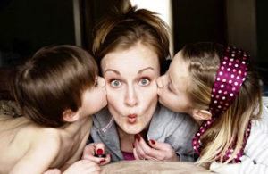 Mom with puckered lips being kissed by kids~PhotograTree~Photo URL    : http://www.flickr.com/photos/lightfalling/2261753548/